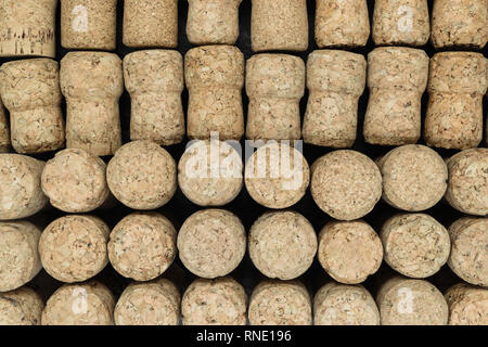 Background of champagne corks. Half of corks lying, half of them standing on black stone background Stock Photo