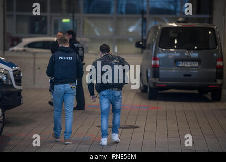 Frankfurt, Germany. 18th Feb, 2019.  A policeman accompanies a man to a terminal at the airport, from where he is to be deported to Afghanistan with a chartered plane in the evening. Photo: Boris Roessler/dpa Credit: dpa picture alliance/Alamy Live News Stock Photo