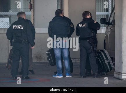 Frankfurt, Germany. 18th Feb, 2019.  Police officers accompany a man (M) to a terminal at the airport, from where he is to be deported to Afghanistan with a chartered plane in the evening. Photo: Boris Roessler/dpa Credit: dpa picture alliance/Alamy Live News Stock Photo