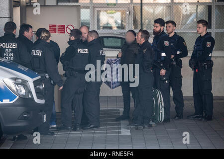 Frankfurt, Germany. 18th Feb, 2019.  Police officers accompany a man (M) to a terminal at the airport, from where he is to be deported to Afghanistan with a chartered plane in the evening. Photo: Boris Roessler/dpa - ATTENTION: The person was pixelated for reasons of personality rights Credit: dpa picture alliance/Alamy Live News Stock Photo