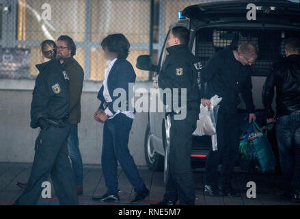 Frankfurt, Germany. 18th Feb, 2019.  In front of his stomach, tied up are the hands of a man (3rd from left), who is fetched from a car by police officers at the airport and taken on a deportation flight to Afghanistan. Photo: Boris Roessler/dpa - ATTENTION: The person was pixelated for reasons of personality rights Credit: dpa picture alliance/Alamy Live News Stock Photo