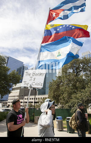 Austin, Texas, USA. 18th Feb, 2019. A protestor holds a stream off flags from Cuba Venezuela, and El Salvador to bring attention to President Trump's call for a National Emergency to build a wall along the border between The United States and Mexico and his call for regime change in Venezuela at Republic Square Park in Austin Texas on President's Day. Credit: Jaime Carrero/ZUMA Wire/Alamy Live News Stock Photo
