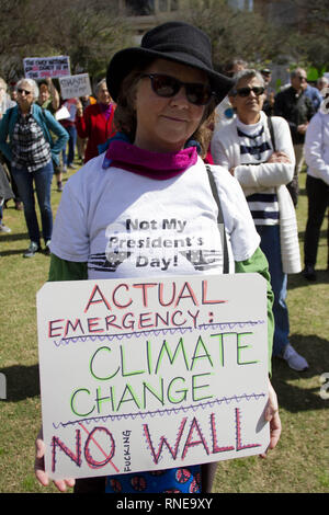 Austin, Texas, USA. 18th Feb, 2019. An unidentified woman holds up a sign denouncing the building of a wall along the Rio Grande to keep immigrants from entering the US and the administration policies instead of trying to find alternatives to combat Global Climate change during the President Day's protest at Republic Square Park in Austin Texas.The protest is part of the Emergency Action protests across the country denouncing President Trump's policies against immigration. Credit: Jaime Carrero/ZUMA Wire/Alamy Live News Stock Photo