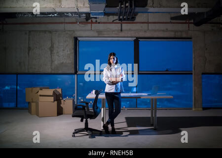 portrait of young female architect on construction site checking documents and business workflow using laptop computer in new startup office Stock Photo