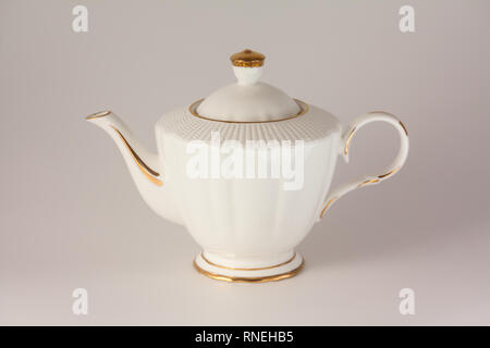 Beautiful white porcelain teapot on white background Stock Photo
