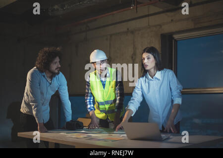 young team of business people in group, architect and engineer on construction site checking documents and business workflow using laptop computer in  Stock Photo