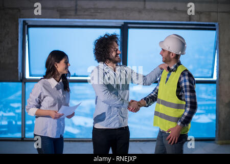 young team of business people in group, architect and engineer on construction site checking documents and business workflow using laptop computer in  Stock Photo