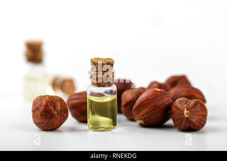 hazelnut oil and nuts isolated on white Stock Photo