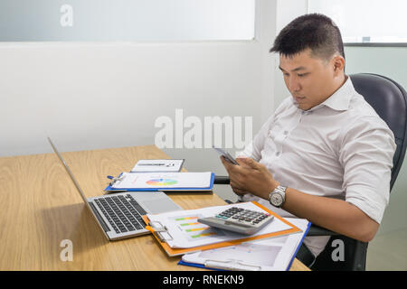 Asian businessman using smartphone in the office Stock Photo