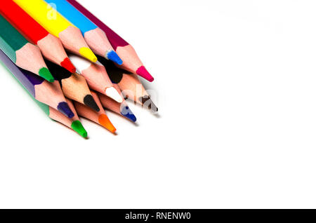 Colourful sharp pencils lie on a white background with copy space top view Stock Photo