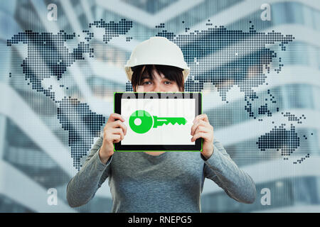 Young woman civil engineer wearing protective helmet using tablet computer gadget for presentation with a green key on display and world map hologram  Stock Photo