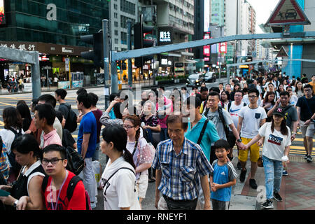 Busy streets packed with People. Hong Kong is one of the most densely populated cities in the world. Stock Photo