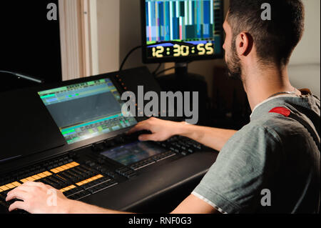 A lighting engineer works with lights technicians control Stock Photo