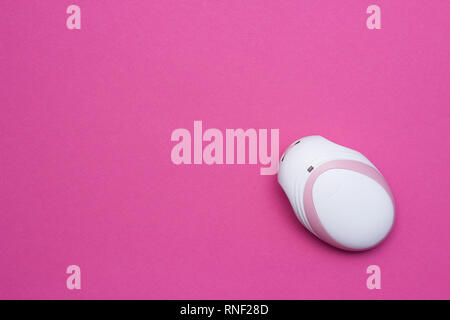 Fetal doppler for listening in a pregnant baby's heartbeat, close-up, pink background, copy space Stock Photo