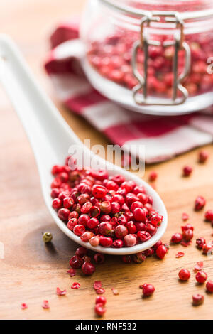 Dried pink peppercorn in spoon. Stock Photo