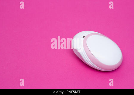 Fetal doppler for listening in a pregnant baby's heartbeat, close-up, pink background, copy space, diagnostic Stock Photo