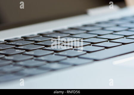 macro color photo of a black laptop keyboard with blurred keys Stock Photo