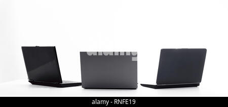 three open laptop in the workplace .isolated on white Stock Photo