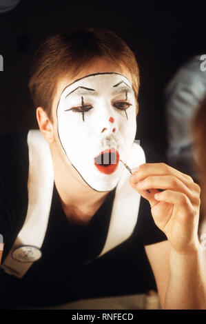 An Airman from Lackland Air Force Base, Texas, applies make-up prior to performing a mime act in the Air Force Talent Contest. Stock Photo