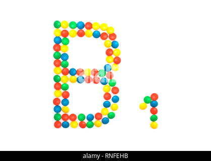 Multi-colored vitamins pills that are lined with the letter Vitamin B1, close-up Stock Photo
