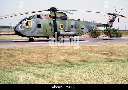 Left side view of a HH-3E Jolly Green Giant helicopter parked on the runway apron. Stock Photo