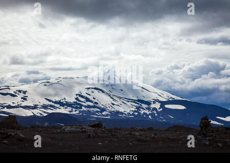 Dramatic sky over snow capped Hekla (Hecla) stratovolcano, one of Icelands most active volcanoes and popular tourist attraction in Southwestern Icelan Stock Photo