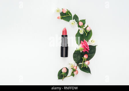 top view of composition with leaves, roses, berries, hrysanthemums and pink lipstick isolated on white Stock Photo
