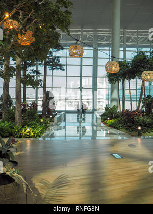 South Korea - October 2018: departure hall of the Incheon International Airport terminal 2 which is known for its green interior with plans and trees Stock Photo