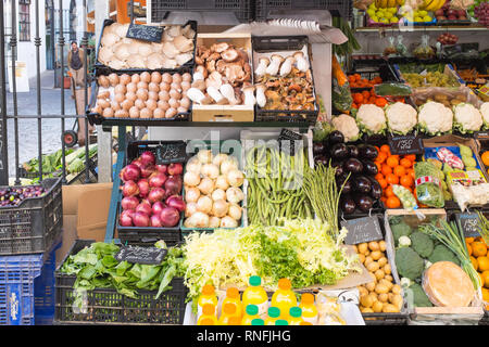 Fresh fruit and vegetables on display outside a small shop in the spanish city of Seville, Andalucia Stock Photo