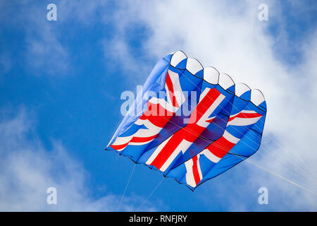 Union Jack flag kite against blue sky on sunny day. Stock Photo