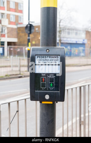Signal button at a pedestrian crossing with Poolway Shopping Centre in the background Stock Photo