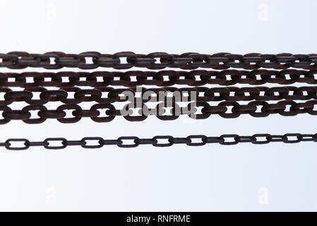 Rusty chains close up shot on a white background. Stock Photo