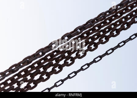 Rusty chains close up shot on a White background. Stock Photo