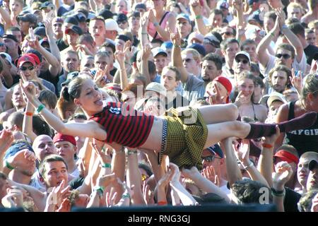 A concert fan is shown body surfing across the top of the crowd during a 'live' performance. Stock Photo