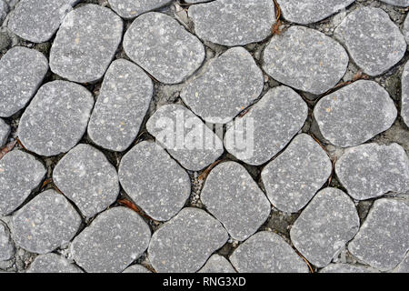 Gray granite cobblestone pavers used for a city street and useful as an abstract background or pattern. Stock Photo