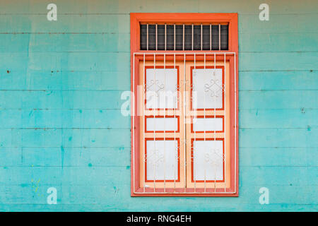 Architecture detail of a window with a turquoise wood wall in the district of Las Penas on the Santa Ana hill in Guayaquil, Ecuador. Stock Photo