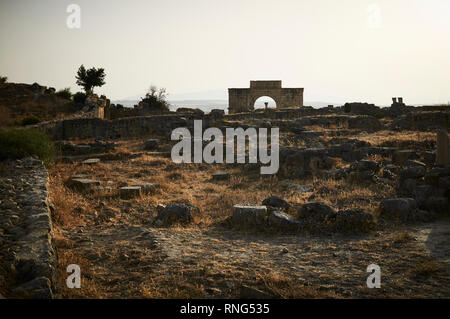 Arch of Caracalla (Triumphal Arch) of Volubilis is a partly excavated Berber and Roman city in Morocco near the city of Meknes. Stock Photo