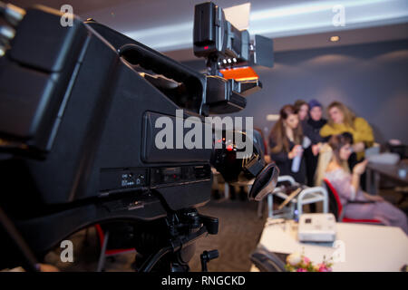 Makeup cosmetic at home. Focus on tripod mounted Video camera screen showing . In front of the camera to recording vlog video live streaming at home Stock Photo