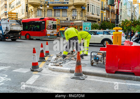 Valencia,Spain - February 18, 2019:  Two workers. Pavement and road repairs in Valenci city. Stock Photo