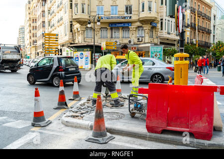Valencia,Spain - February 18, 2019:  Two workers. Pavement and road repairs in Valenci city. Stock Photo
