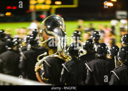 High school marching band during half time show at American football game. Stock Photo