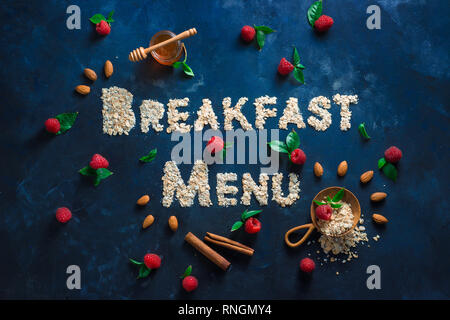 Breakfast menu header, words written with oatmeal. Healthy eating concept on a dark background with copy space. Stock Photo