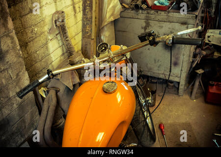 Interior view of local motorcycle workshop garage full of various motorbikes and spare parts under repair Stock Photo