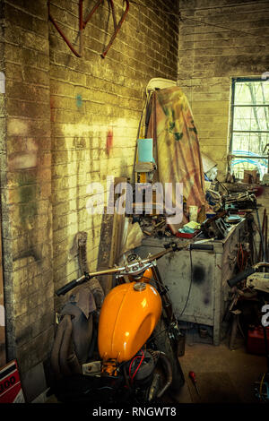 Interior view of local motorcycle workshop garage full of various motorbikes and spare parts under repair Stock Photo