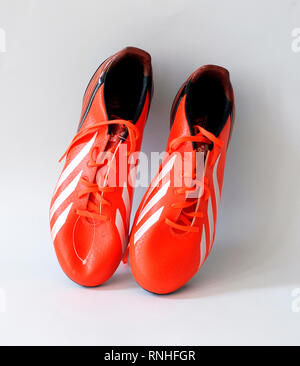 Adidas F30 football boots.Color orange infrared. Made by natural skin, Tacos 2.0 with three traction edges. Season 2013 - 2014 Stock Photo - Alamy