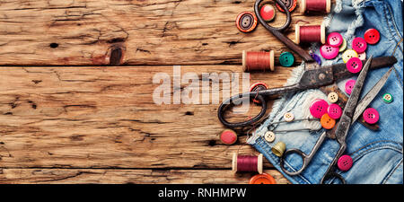 Spools of thread and basic sewing tools on wooden tabletop Stock Photo