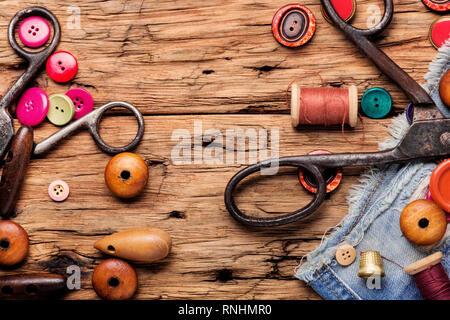 Spools of thread and basic sewing tools on wooden tabletop Stock Photo