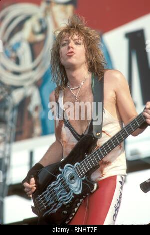 Bassist Jeff Pilson is shown performing on stage during a Dokken concert. Stock Photo