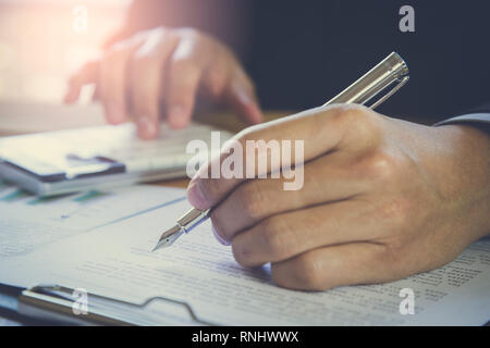 Business man signing a contract. Owns the business sign personally, director of the company, solicitor. Real estate agent holding house, financial or  Stock Photo