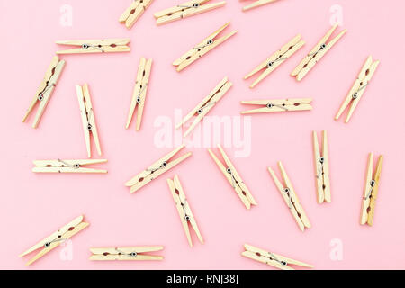 Wooden clothes pegs on pink background. Zero waste Stock Photo
